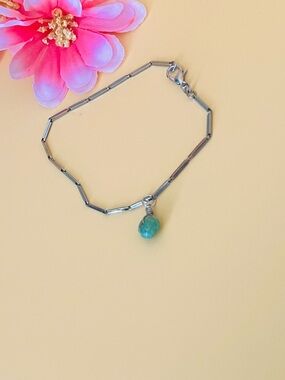 Silver chain bracelet wi a turquoise bead charm